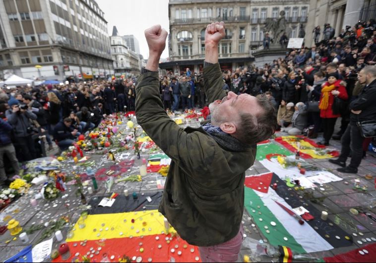 A man reacts at a street memorial following Tuesday's bomb attacks in Brussels A man reacts at a street memorial following Tuesday's bomb attacks in Brussels