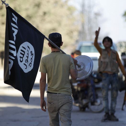 A rebel fighter takes away a flag that belonged to Islamic State militants in Akhtarin village, after rebel fighters advanced in the area, in northern Aleppo Governorate, Syria, October 7, 2016